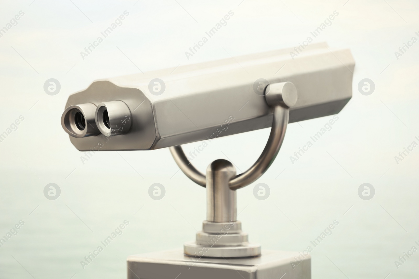 Photo of Metal tower viewer installed outdoors. Mounted binoculars