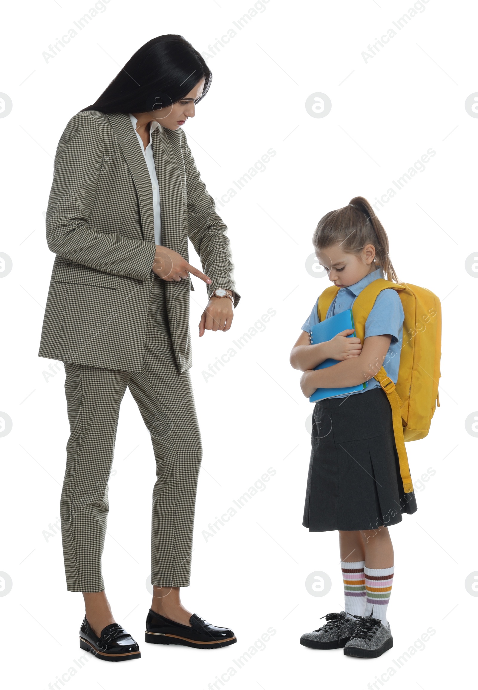 Photo of Teacher pointing on wrist watch while scolding pupil for being late against white background