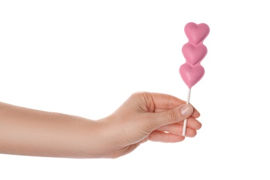 Photo of Woman holding heart shaped lollipops made of chocolate on white background, closeup