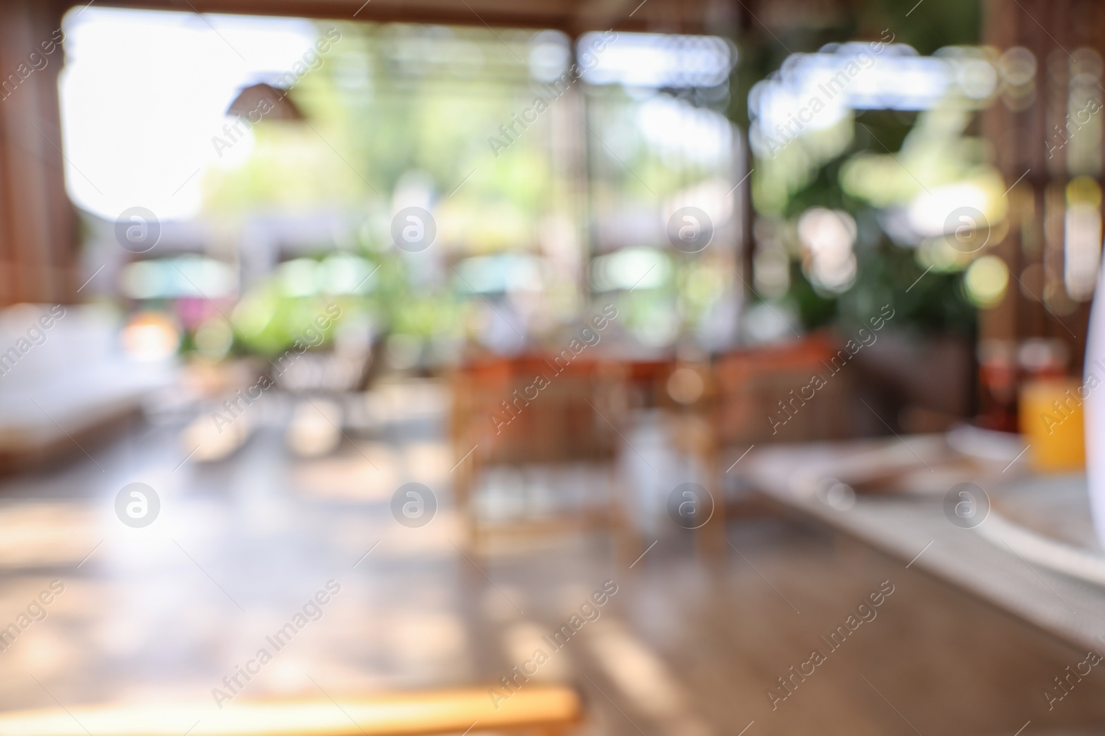 Photo of Blurred view of comfortable cafeteria with furniture