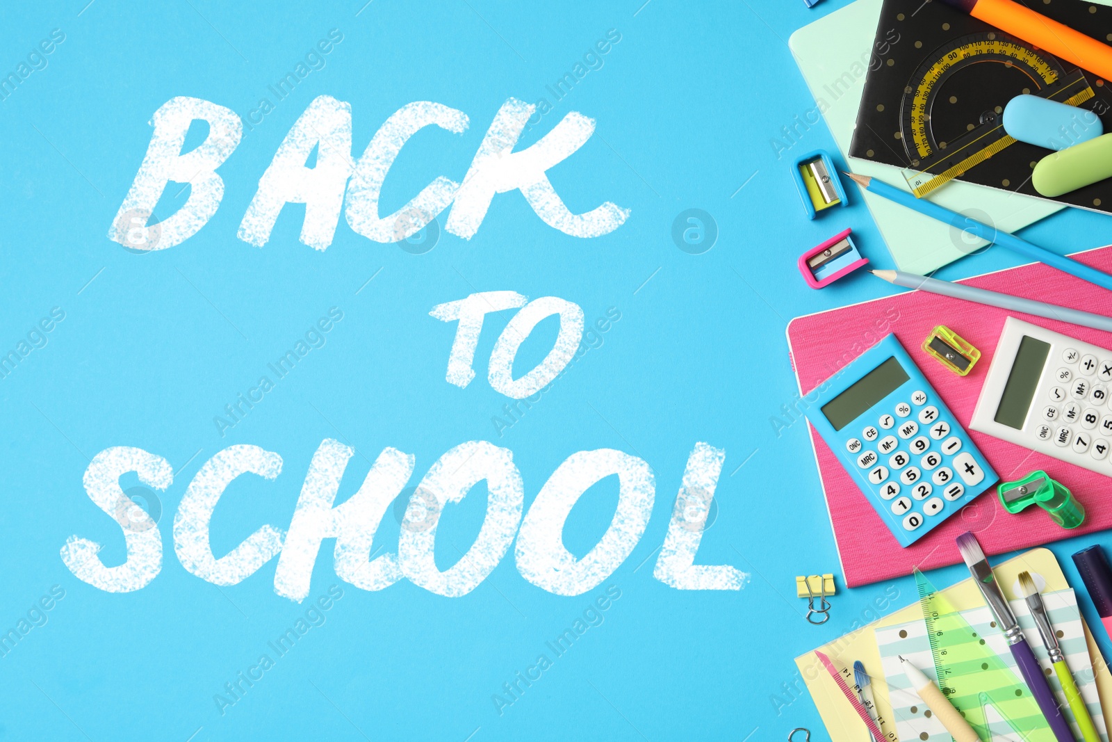 Image of Text Back To School and different stationery on blue background, flat lay