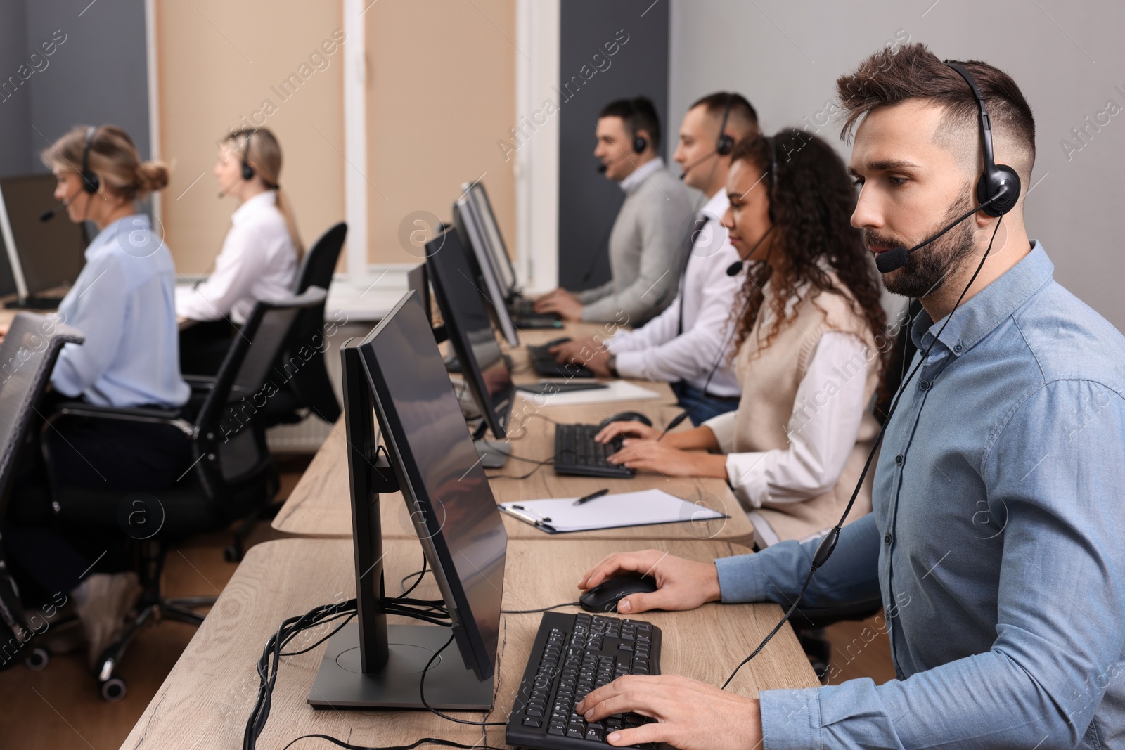 Photo of Call center operators working in modern office