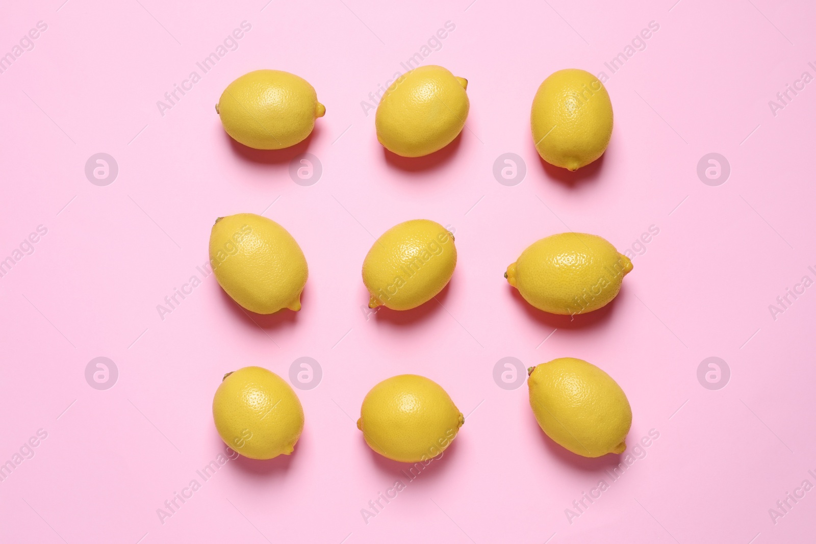 Photo of Fresh ripe lemons on pink background, flat lay