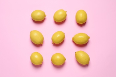 Fresh ripe lemons on pink background, flat lay