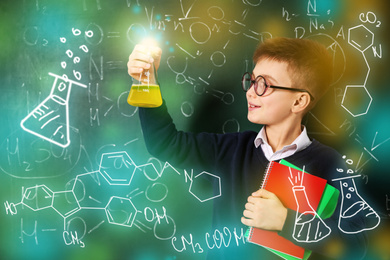 Schoolboy with flask and notebooks near chalkboard with chemical formulas