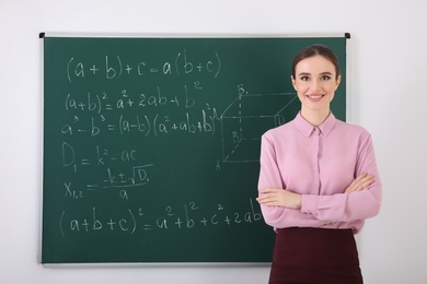 Portrait of young female teacher in classroom