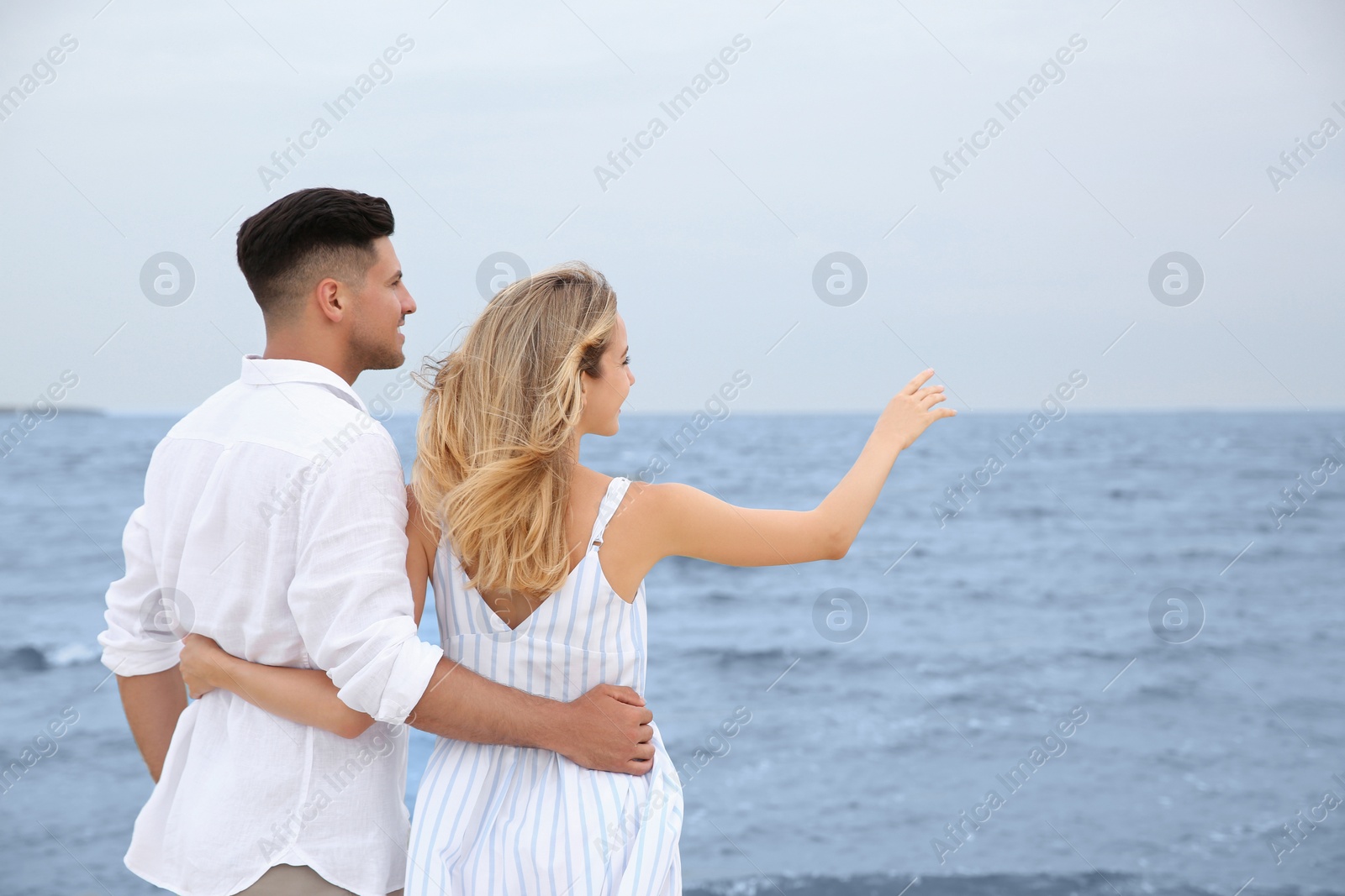 Photo of Happy couple having romantic walk on beach