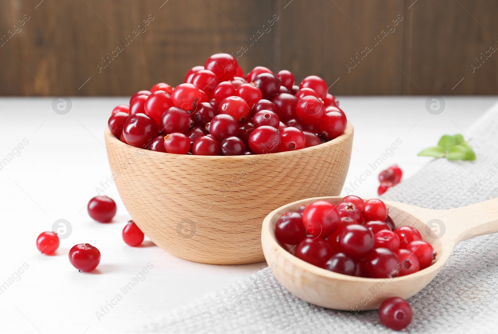 Photo of Fresh ripe cranberries on white wooden table, closeup