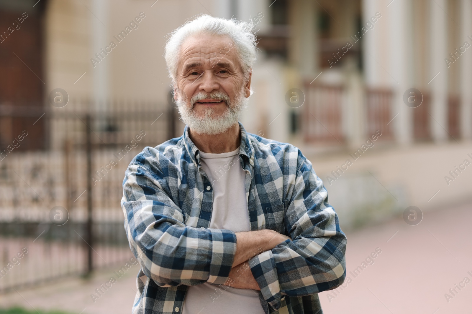 Photo of Portrait of happy grandpa with grey hair outdoors