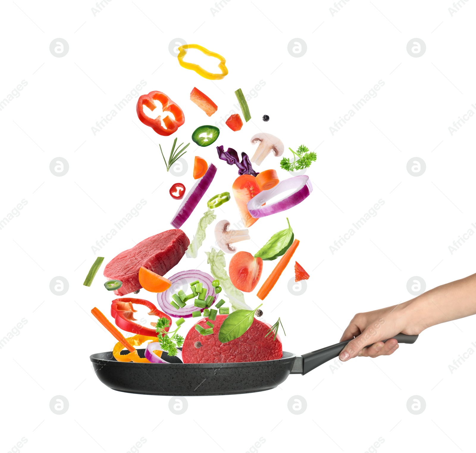 Image of Woman holding nonstick frying pan with falling beef slices and vegetables on white background. Process of cooking