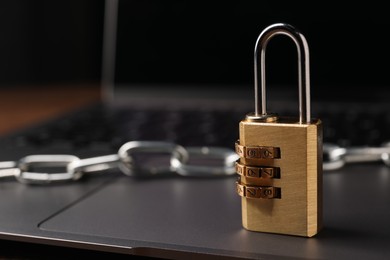 Photo of Cyber security. Padlock on laptop, closeup and space for text