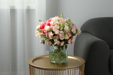 Photo of Beautiful bouquet of fresh flowers on coffee table in room, space for text