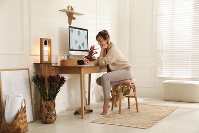 Photo of Woman at workplace in room. Interior design
