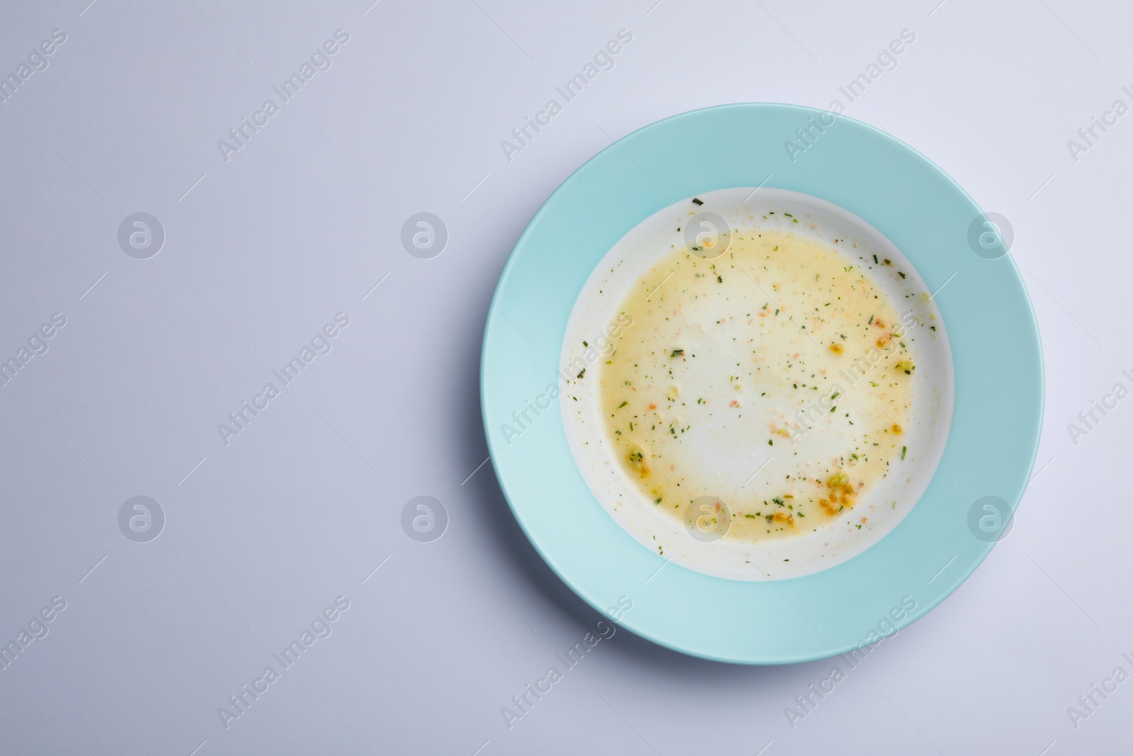 Photo of Dirty plate with food leftovers on white background, top view