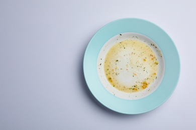 Dirty plate with food leftovers on white background, top view