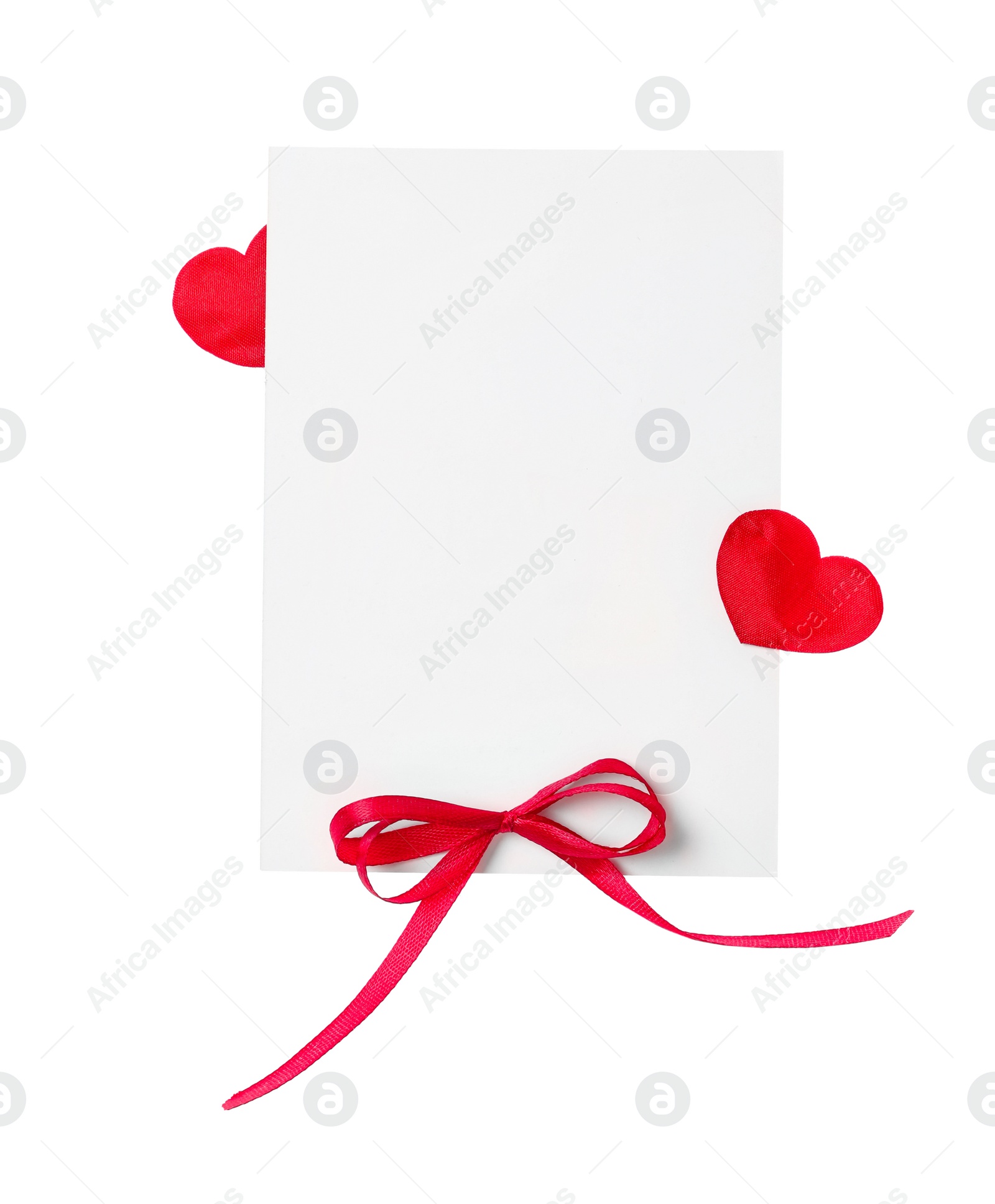 Photo of Blank card with red bow and red decorative on white background, top view. Valentine's Day celebration