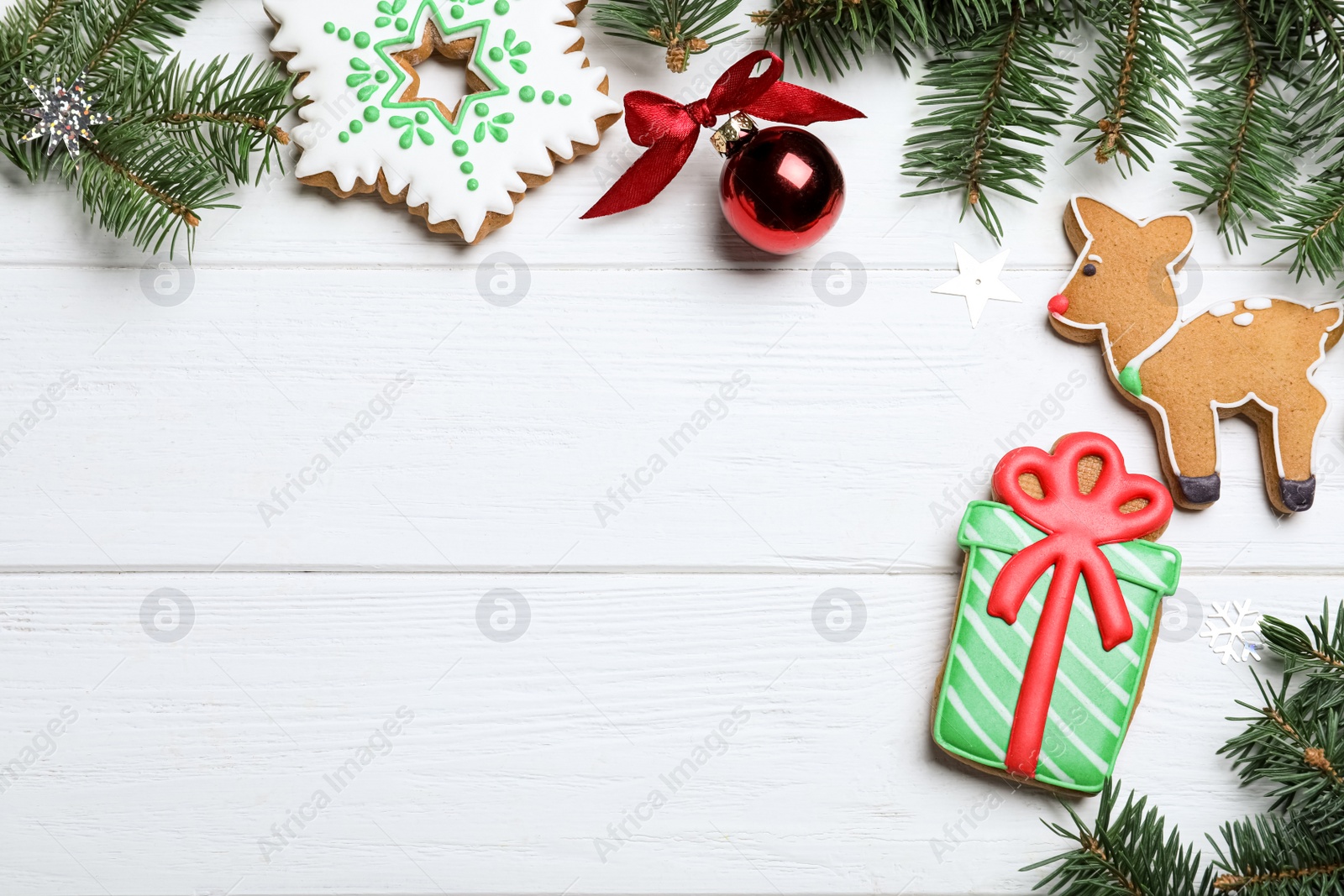 Photo of Flat lay composition with tasty homemade Christmas cookies on white wooden table, space for text