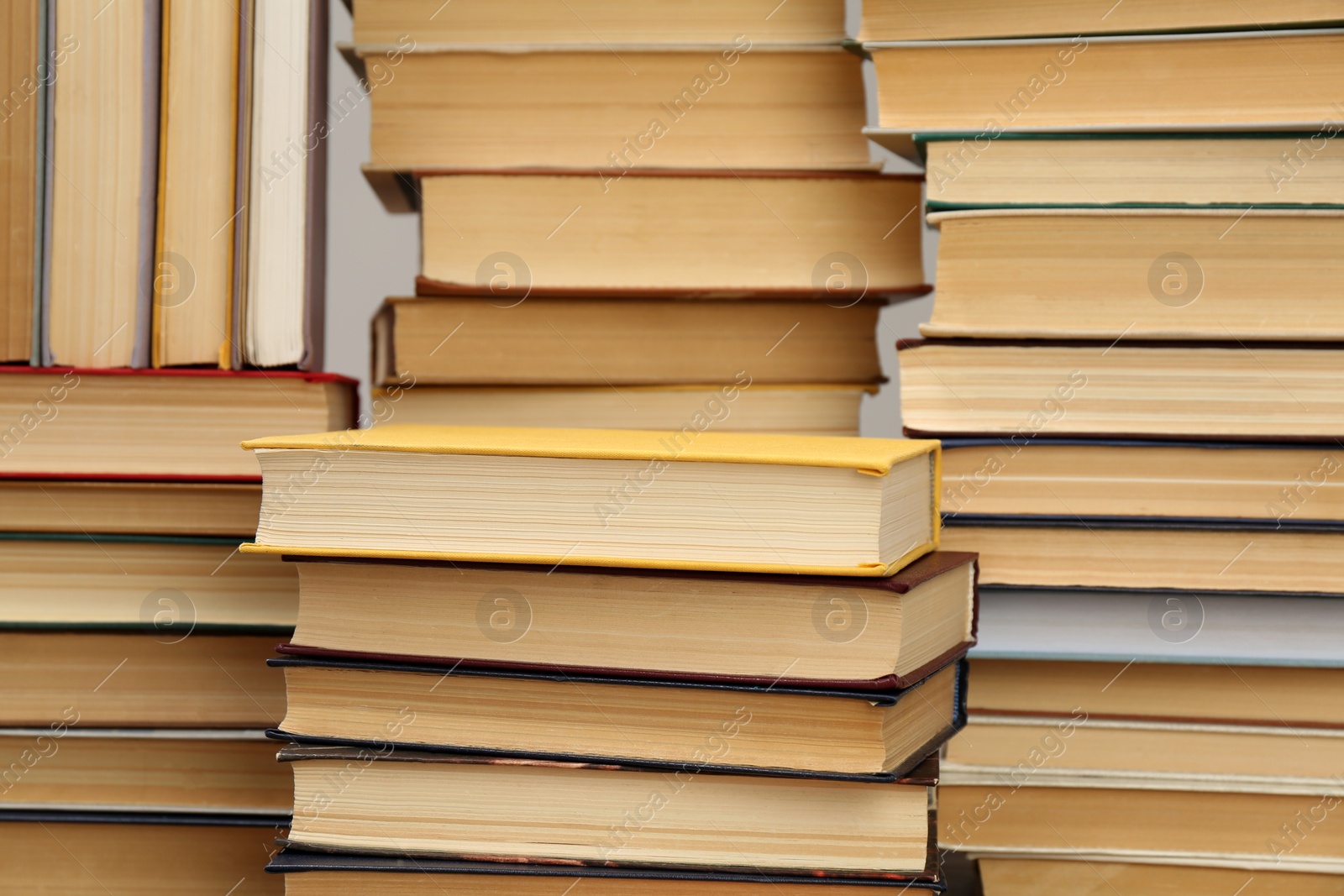 Photo of Many hardcover books as background. Library material