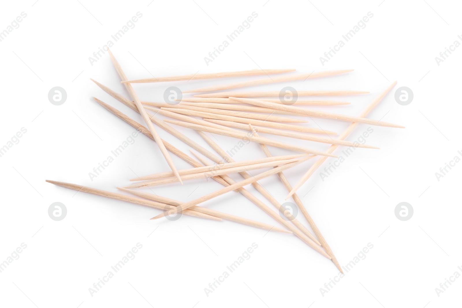 Photo of Heap of wooden toothpicks on white background