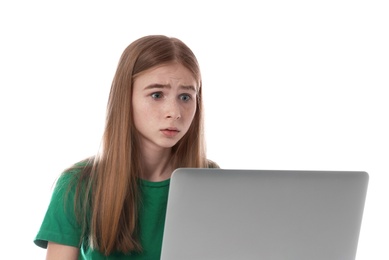 Photo of Shocked teenage girl with laptop on white background. Danger of internet