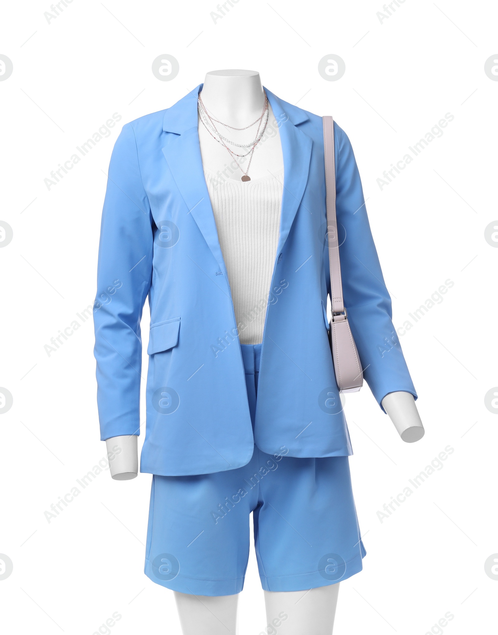 Photo of Female mannequin dressed in light blue suit and top with accessories isolated on white. Stylish outfit