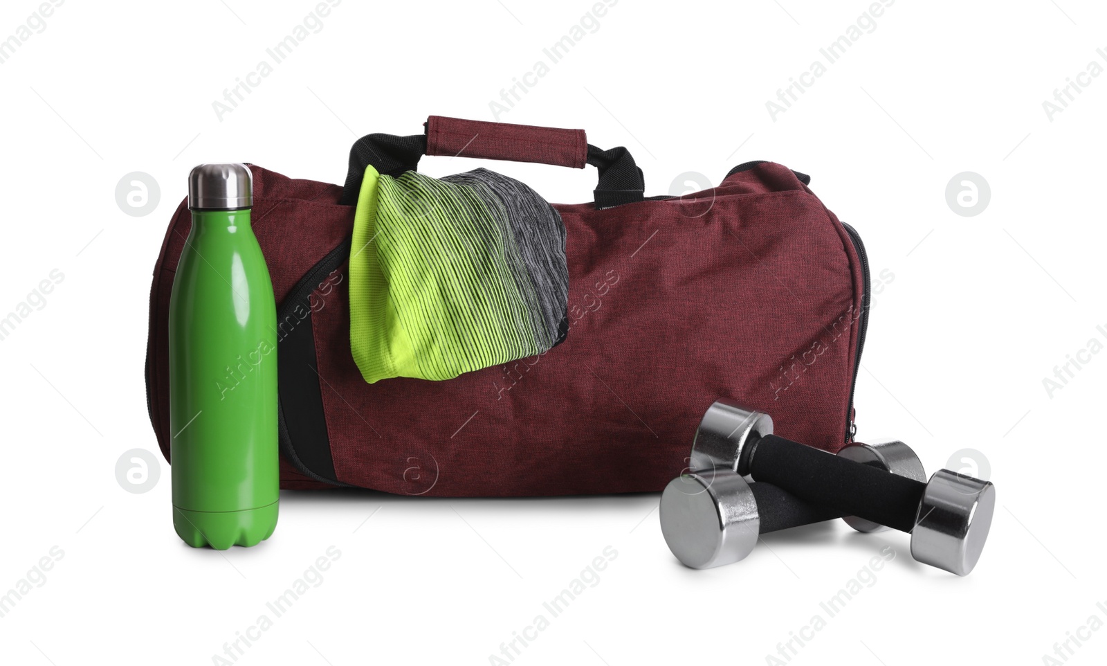 Photo of Sports bag and gym equipment on white background