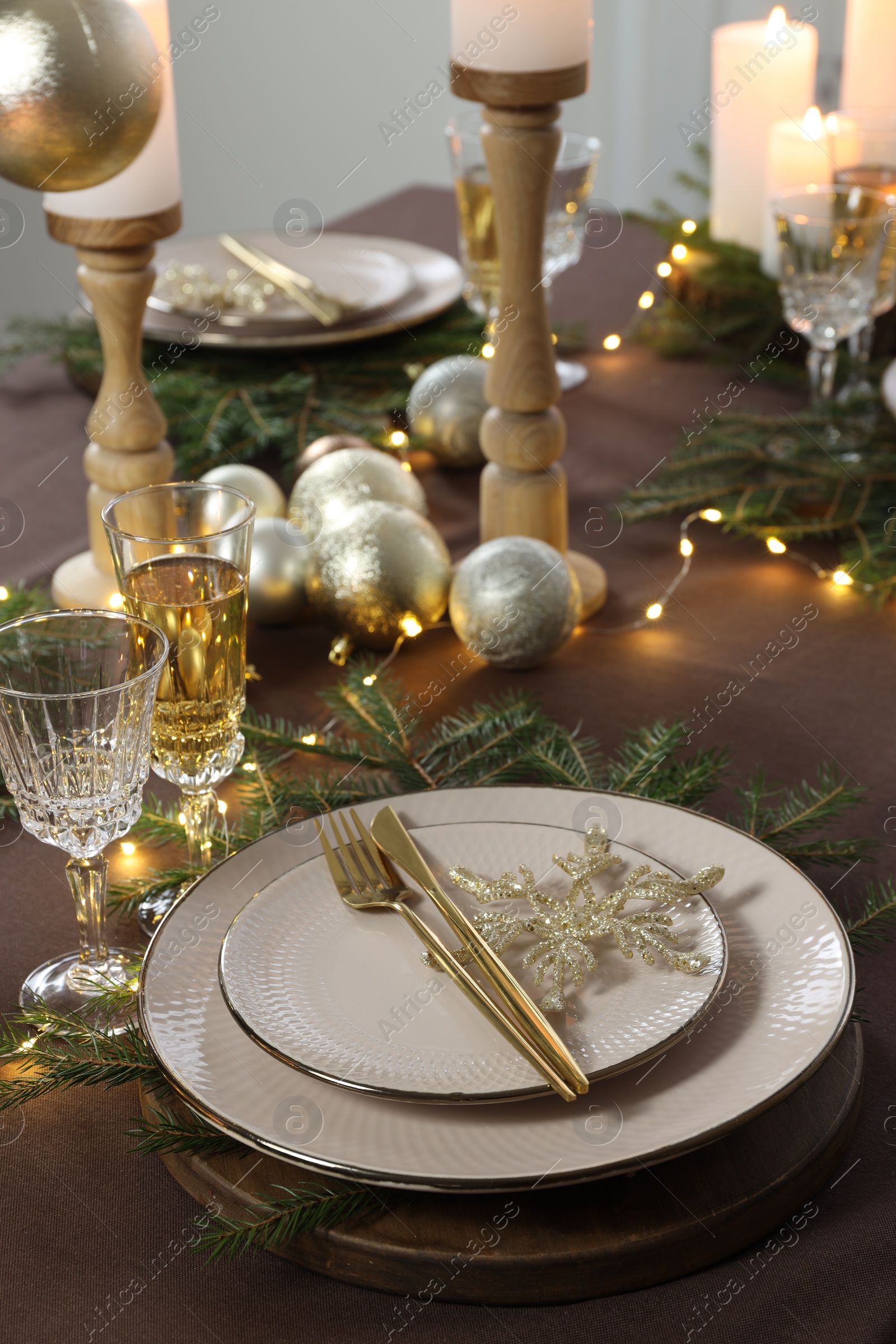 Photo of Table setting with festive lights and Christmas decor