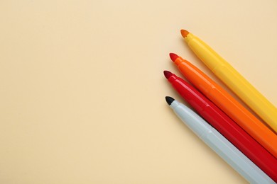 Photo of Different colorful markers on beige background, flat lay. Space for text