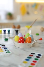 Happy Easter. Painted eggs and watercolor on white marble table indoors