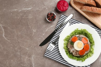 Delicious aspic with meat and vegetables served on grey table, flat lay. Space for text