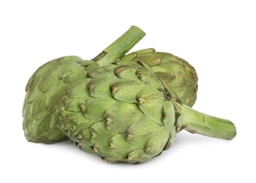 Photo of Whole fresh raw artichokes on white background