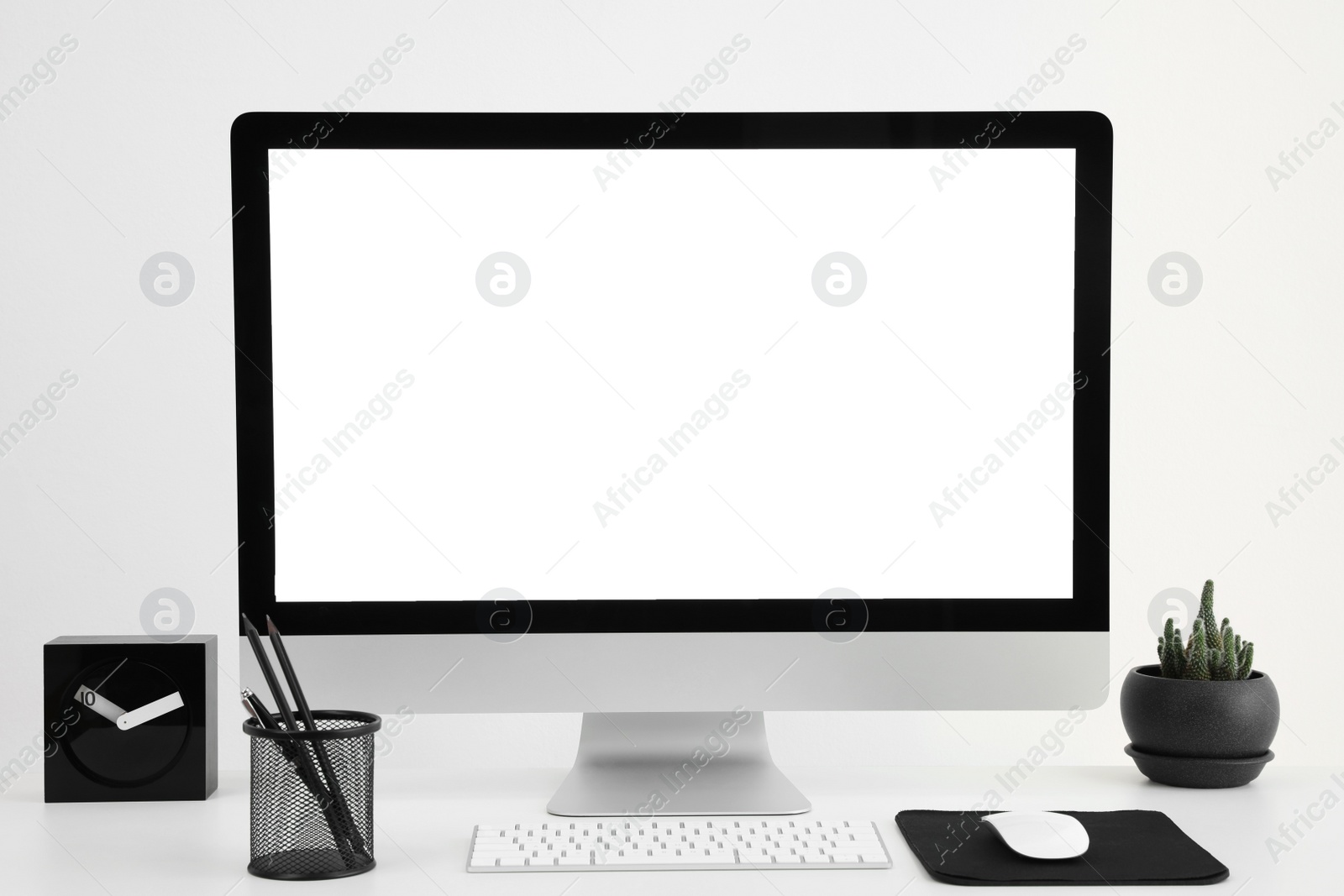 Photo of Modern computer with blank screen on desk, space for design. Comfortable workplace