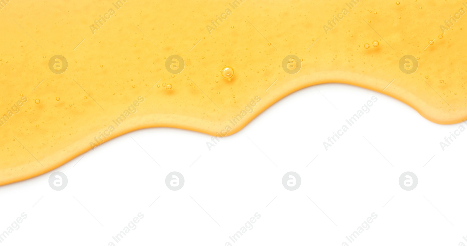 Photo of Tasty natural honey flowing isolated on white, top view