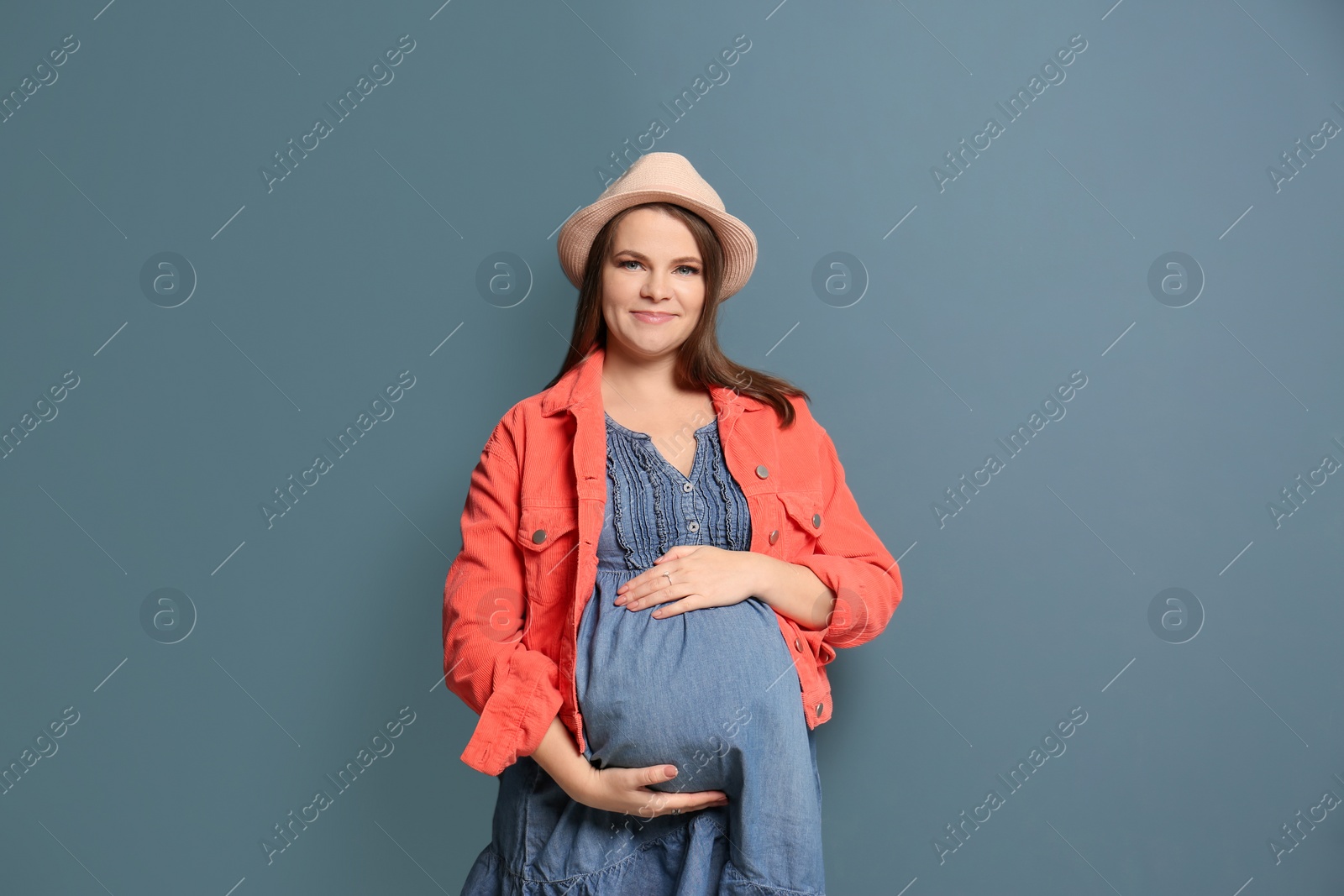 Photo of Beautiful pregnant woman on color background