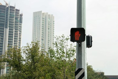 Photo of Traffic lights on city street. Road rules