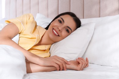 Photo of Woman lying in comfortable bed with white linens