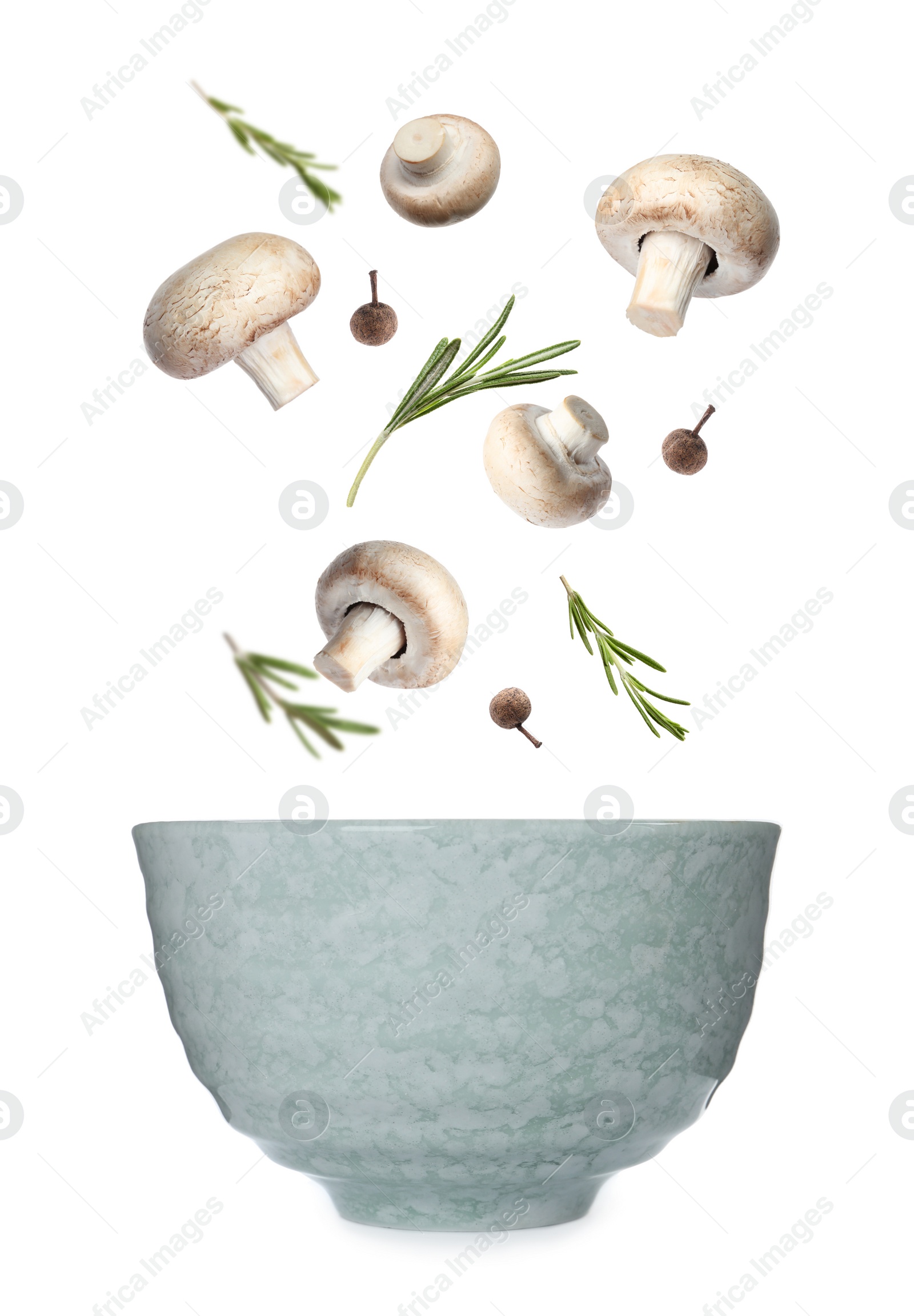 Image of Fresh mushrooms, rosemary and peppercorns falling into bowl on white background