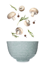 Image of Fresh mushrooms, rosemary and peppercorns falling into bowl on white background