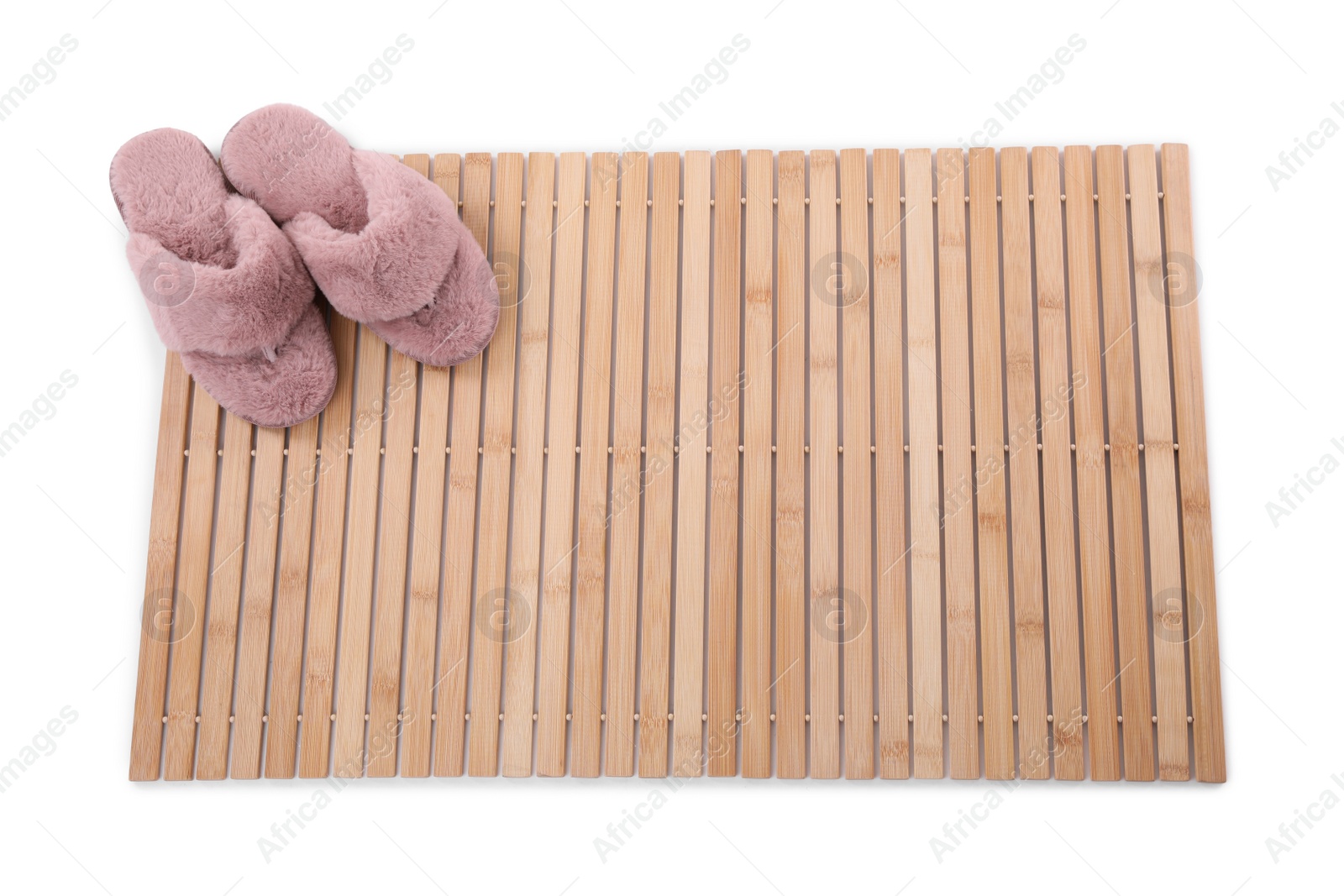 Photo of Bamboo rug with stylish soft slippers isolated on white, top view. Bath accessory