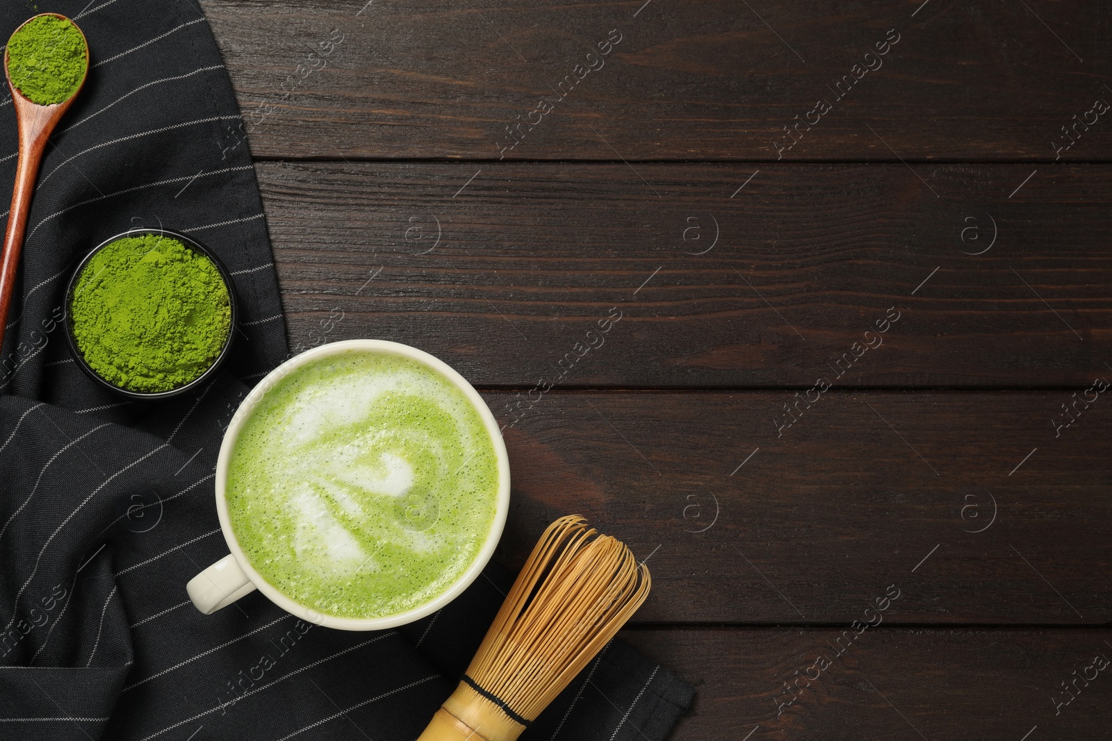 Photo of Flat lay composition with tasty matcha latte on dark wooden table, space for text