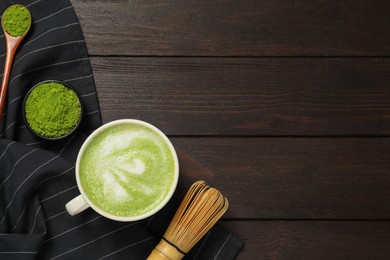 Flat lay composition with tasty matcha latte on dark wooden table, space for text