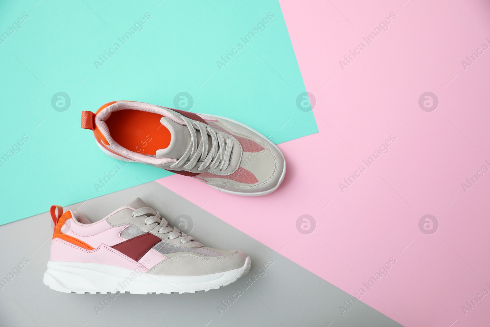 Photo of Stylish women's sneakers on color background, top view