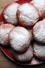 Photo of Delicious sweet buns with powdered sugar on plate, top view