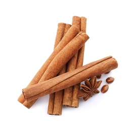 Photo of Aromatic cinnamon sticks and anise on white background