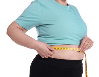 Photo of Overweight woman measuring waist with tape on white background, closeup