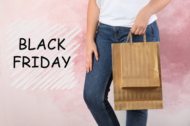 Image of Woman with shopping bags on pink background, closeup. Black Friday Sale