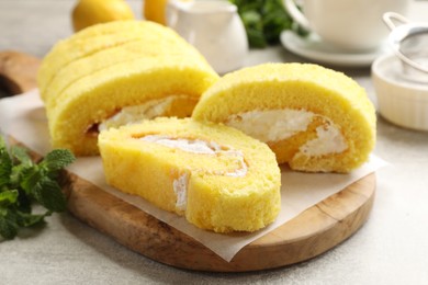 Delicious cake roll with cream filling on table, closeup