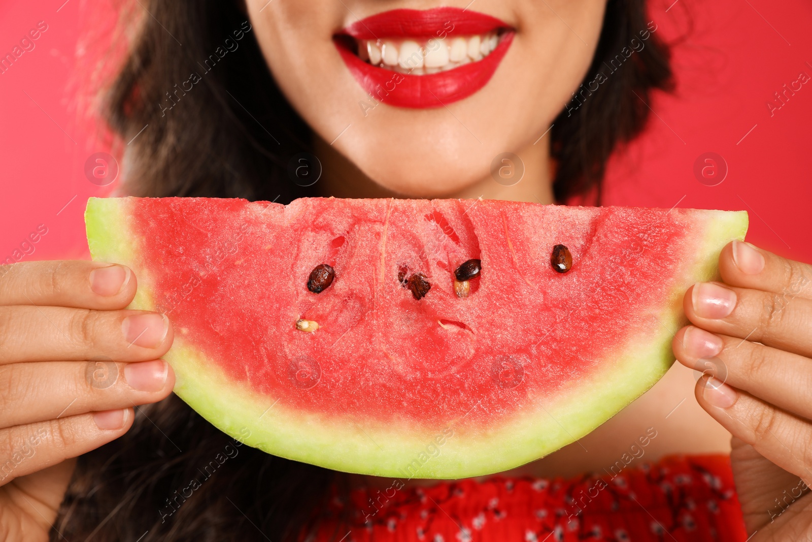 Photo of Beautiful young woman with watermelon on red background, closeup