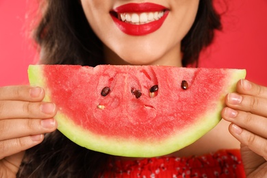 Photo of Beautiful young woman with watermelon on red background, closeup