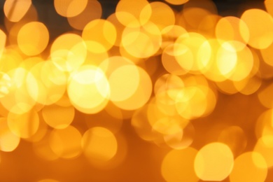 Photo of Gold glitter with bokeh effect on dark background